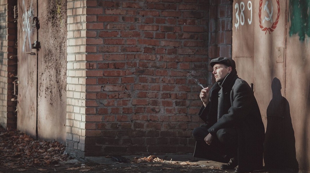 detective in trench coat smoking pipe